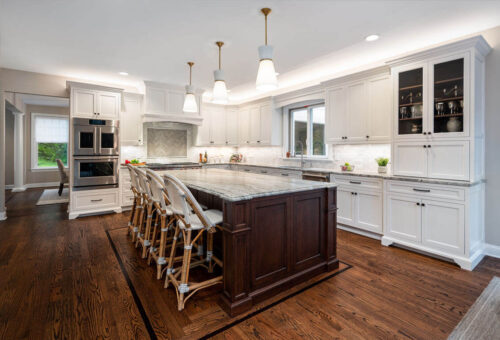 This is a picture of a quaint white kitchen in Henderson Nevada with custom cabinets made by Kountry Kraft Cabinetry. 