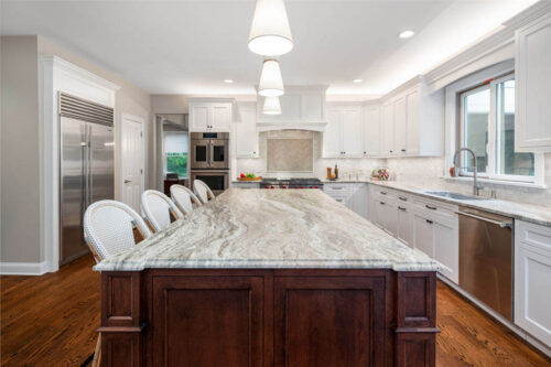 This is a picture of a white kitchen in Henderson Nevada with cabinetry made by Kountry Kraft Cabinetry. 