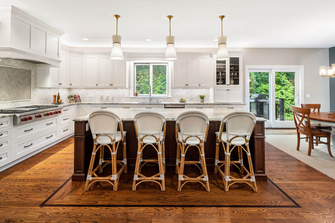 This is a picture of an elegant white kitchen with cherry wood in Henderson NV with custom made cabinetry by Kountry Kraft Cabinetry.