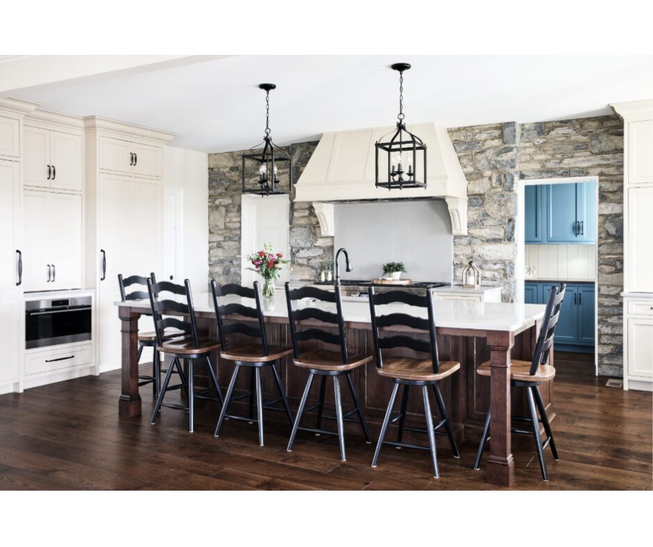 This Lebanon, PA kitchen remodel transforms a home with Kountry Kraft’s Penn Line custom cabinetry, finished in Benjamin Moore Hush AF-95. The kitchen blends classic design with modern functionality, featuring a large custom range hood over a Wolf double range, a vibrant blue butler’s pantry, and a spacious island seating six