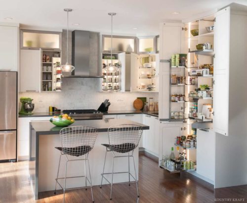Hidden Cabinet Storage Ideas Throughout a Large White Kitchen Custom cabinet storage ideas visibly shown in a large white kitchen designed by kessebohmer