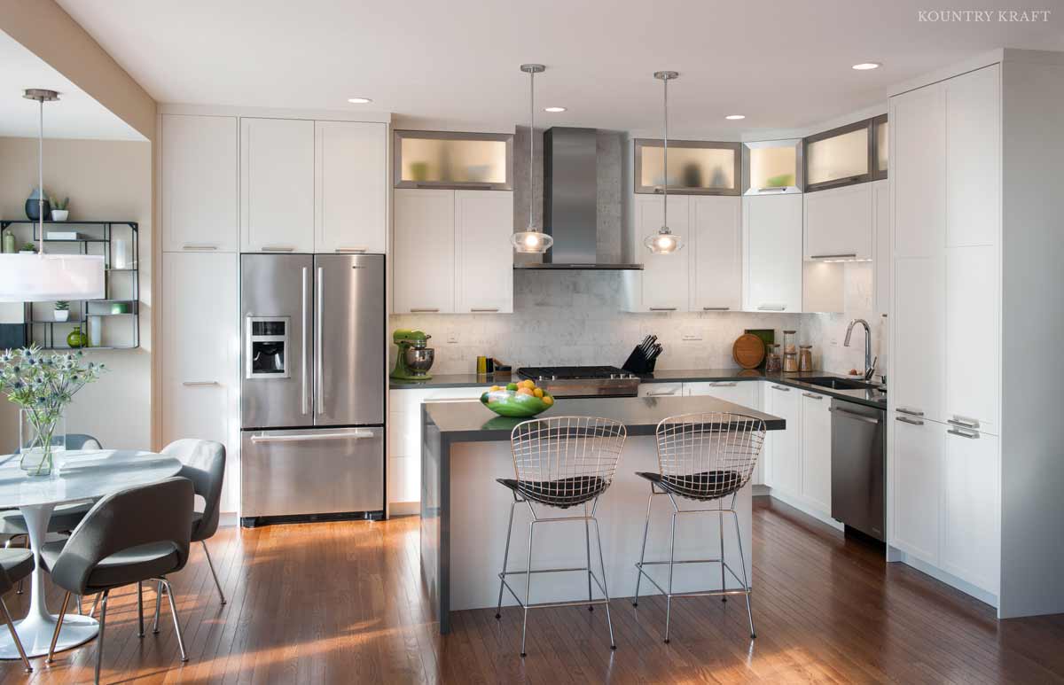 Large White Kitchen with Hidden Cabinet Storage Ideas Large white kitchen with many hidden cabinet storage ideas throughout the perimeter of the kitchen