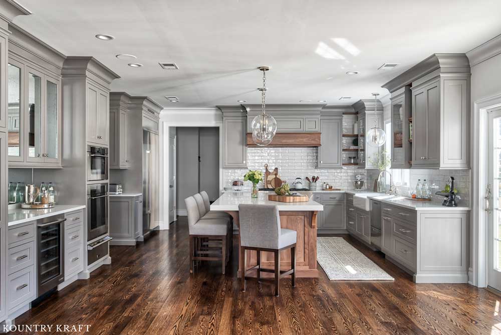 This Kitchen Features A Transitional Design Style This L Shaped Kitchen Featuring Gray Kitchen Cabinets Was Designed To Feature A Transitional Design Style