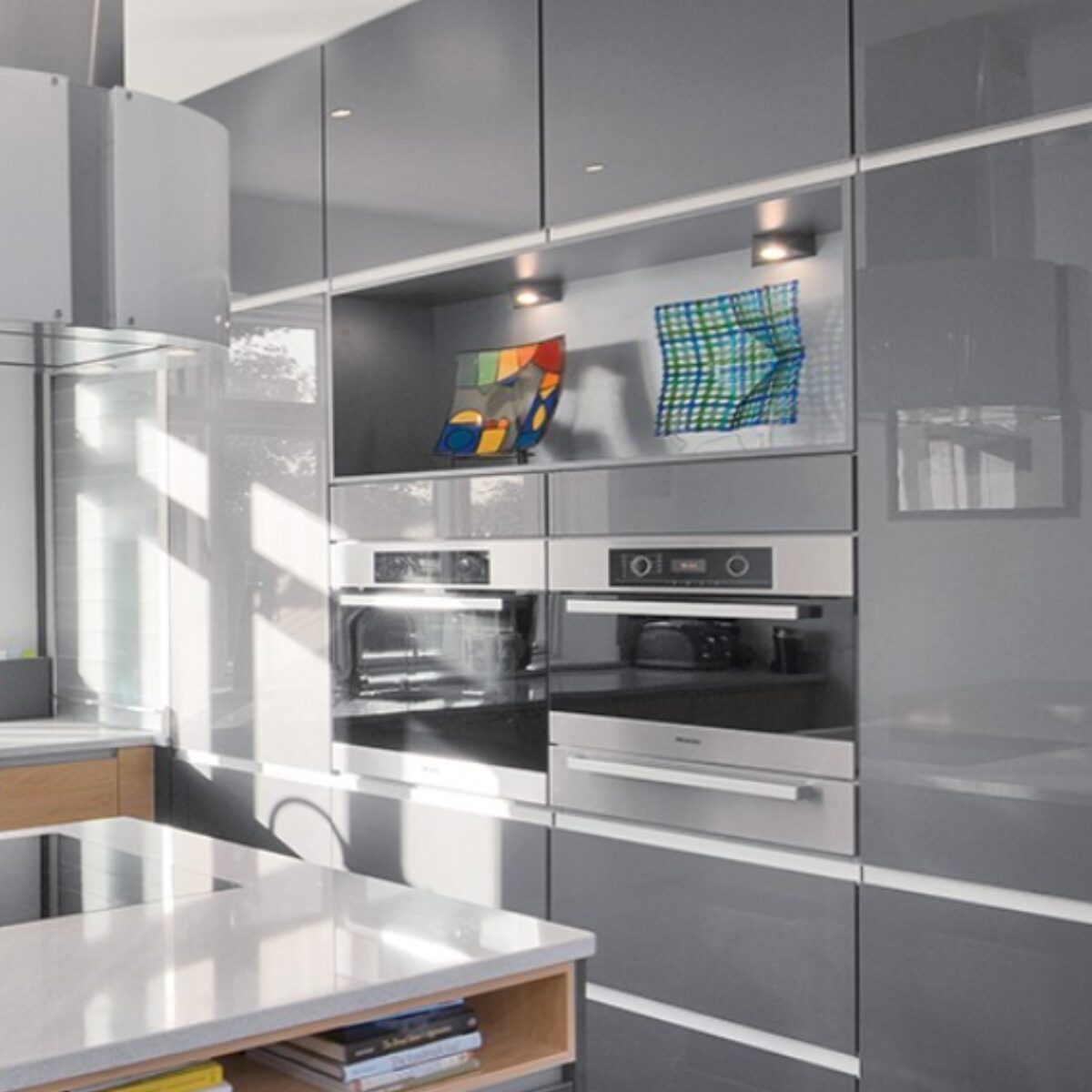 Gray high gloss cabinets by Kountry Kraft Cabinetry.