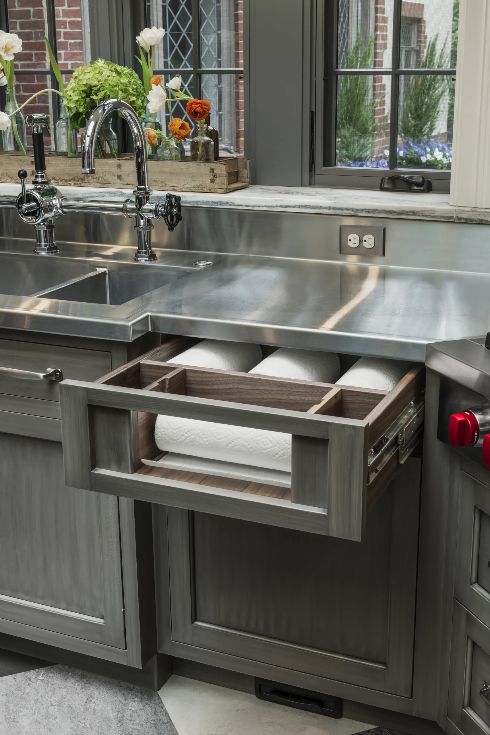 Paper towel holders and storage in a drawer by Kountry Kraft Cabinetry.