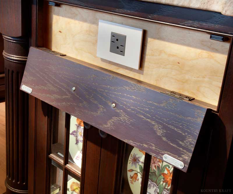 Custom Panel Crafted into Custom Cabinetry to Allow for Cabinets to Hide Electrical Outlets so they are Not Seen by Guests Custom Panel Crafted into Custom Cabinetry to Allow for Cabinets with Hidden Electrical Outlets