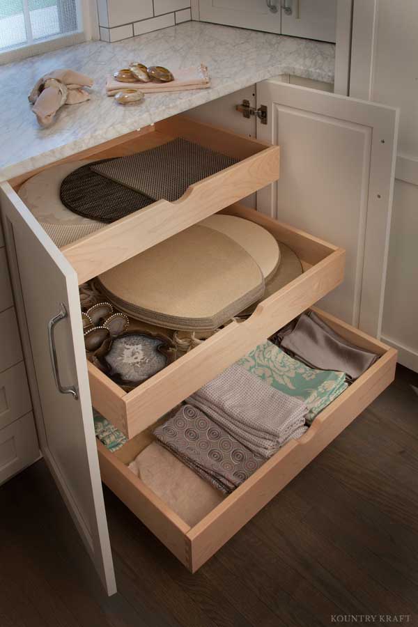 White storage cabinets by Kountry Kraft Cabinetry.