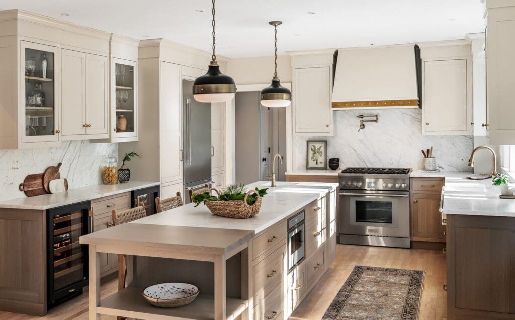 Two-tone kitchen cabinetry combining rift cut white oak and pale warm gray painted cabinets.