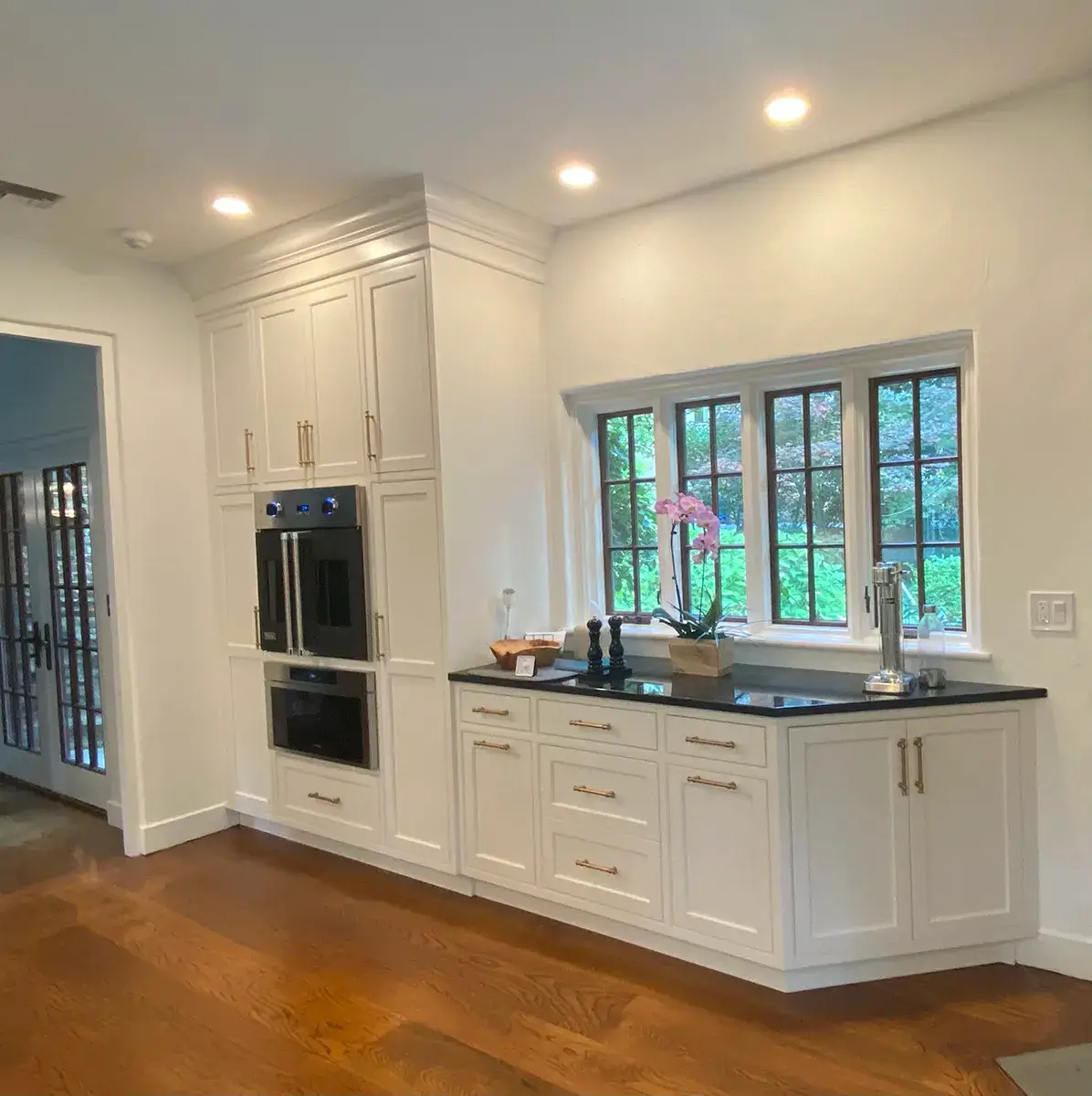 An image of White Cabinets and Black Granite